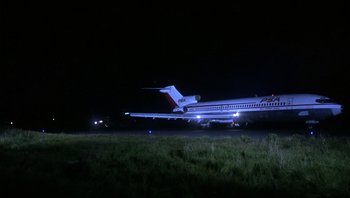 Movie still from “Bullitt” (1968), directed by Peter Yates – An airplane that is sitting in the grass at night; Extreme Wide shot, Low angle