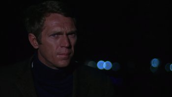 Movie still from “Bullitt” (1968), directed by Peter Yates – A person wearing a jacket; Close Up shot, Over the shoulder angle