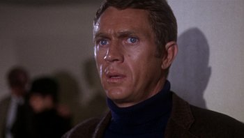 Movie still from “Bullitt” (1968), directed by Peter Yates – A person wearing a sweater; Close Up shot, Over the shoulder angle