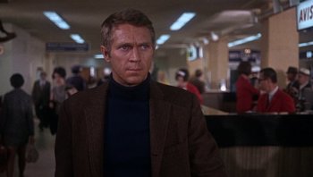 Movie still from “Bullitt” (1968), directed by Peter Yates – A man wearing a brown jacket and a blue shirt; Medium shot, Over the shoulder angle
