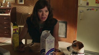 Movie still from “Bumblebee” (2018), directed by Travis Knight – A woman sitting at a table with a box of cereal; Close Up shot, Over the shoulder angle