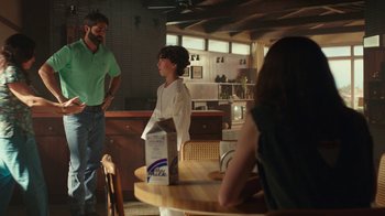 Movie still from “Bumblebee” (2018), directed by Travis Knight – A man and a woman standing at a dining table; Medium shot, Over the shoulder angle