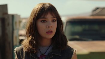 Movie still from “Bumblebee” (2018), directed by Travis Knight – A young woman with long brown hair wearing a necklace; Close Up shot, Over the shoulder angle