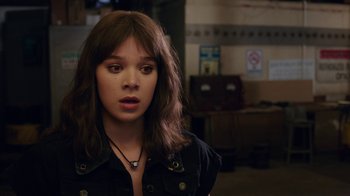 Movie still from “Bumblebee” (2018), directed by Travis Knight – A young woman with long brown hair wearing a black shirt; Close Up shot, Over the shoulder angle
