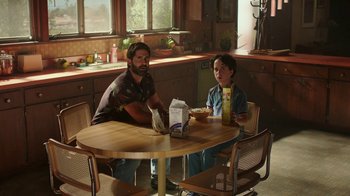 Movie still from “Bumblebee” (2018), directed by Travis Knight – A man and a boy sitting at a table in a kitchen; Medium shot, High angle