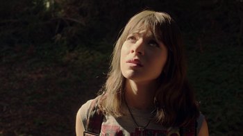 Movie still from “Bumblebee” (2018), directed by Travis Knight – A woman with long brown hair looking up at the sky; Close Up shot, Low angle