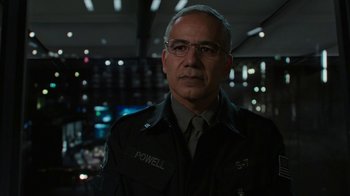 Movie still from “Bumblebee” (2018), directed by Travis Knight – A man in a police uniform in front of a window; Close Up shot, Over the shoulder angle