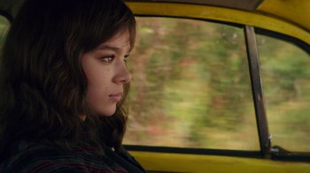 Movie still from “Bumblebee” (2018), directed by Travis Knight – A woman sitting in the back seat of a car looking out the window; Close Up shot, High angle