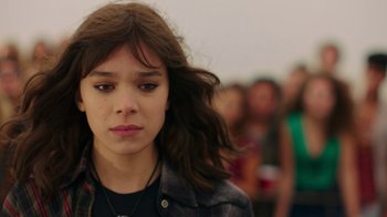 Movie still from “Bumblebee” (2018), directed by Travis Knight – A woman with long brown hair is looking at the camera; Close Up shot, Over the shoulder angle