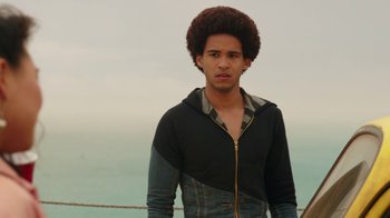 Movie still from “Bumblebee” (2018), directed by Travis Knight – A young man standing on top of a pier; Medium shot, Low angle