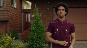 Movie still from “Bumblebee” (2018), directed by Travis Knight – A young man standing in front of a house; Medium shot, Low angle