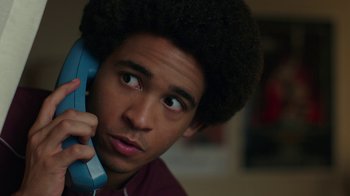 Movie still from “Bumblebee” (2018), directed by Travis Knight – A young man holding a phone up to his ear; Close Up shot, Low angle