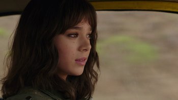 Movie still from “Bumblebee” (2018), directed by Travis Knight – A young woman with long brown hair looking off into the distance; Close Up shot, Over the shoulder angle