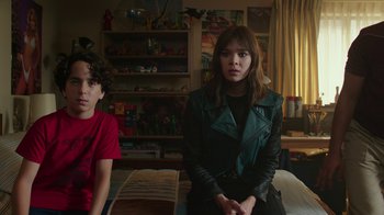 Movie still from “Bumblebee” (2018), directed by Travis Knight – Two young people sitting on a bed in a room; Medium shot, Over the shoulder angle