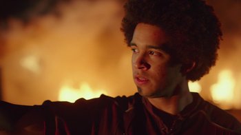 Movie still from “Bumblebee” (2018), directed by Travis Knight – A man with a curly hair is looking to his left; Close Up shot, Over the shoulder angle