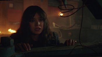 Movie still from “Bumblebee” (2018), directed by Travis Knight – A woman is looking over a railing in the dark; Close Up shot, Over the shoulder angle