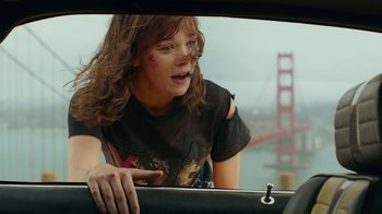 Movie still from “Bumblebee” (2018), directed by Travis Knight – A woman in black shirt driving a car near a golden gate bridge; Medium shot, Over the shoulder angle