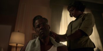 Movie still from “Fargo” (2014), created by Noah Hawley – An older man getting his hair cut by a woman; Close Up shot, Over the shoulder angle