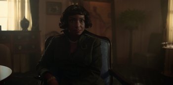 Movie still from “Fargo” (2014), created by Noah Hawley – A woman sitting in a chair in a dark room; Close Up shot, Over the shoulder angle
