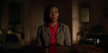 Movie still from “Fargo” (2014), created by Noah Hawley – A woman sitting at a table in front of a window; Medium shot, Low angle