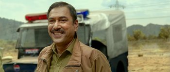 Movie still from “Bunty Aur Babli 2” (2021), directed by Varun V. Sharma – A person smiling for a picture; Close Up shot, Low angle