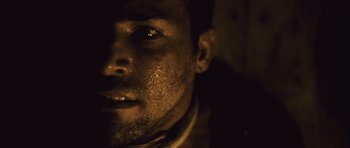 Movie still from “Buried” (2010), directed by Rodrigo Cortés – A man's face in the dark; Extreme Close Up shot, Low angle