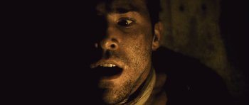 Movie still from “Buried” (2010), directed by Rodrigo Cortés – A man's face in the dark; Close Up shot, Overhead angle