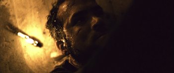 Movie still from “Buried” (2010), directed by Rodrigo Cortés – A person's face in a dark room; Extreme Close Up shot, Low angle