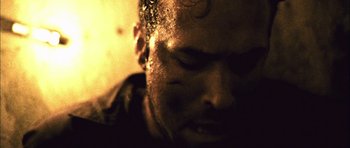 Movie still from “Buried” (2010), directed by Rodrigo Cortés – A man's face in the dark; Extreme Close Up shot, High angle
