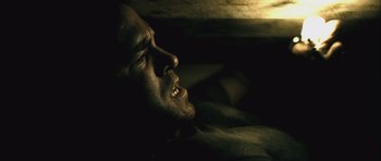 Movie still from “Buried” (2010), directed by Rodrigo Cortés – A person laying down with his mouth open; Close Up shot, High angle