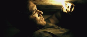 Movie still from “Buried” (2010), directed by Rodrigo Cortés – A person laying on the ground; Close Up shot, High angle