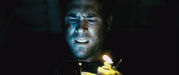Movie still from “Buried” (2010), directed by Rodrigo Cortés – A person holding a lit candle; Close Up shot, Low angle