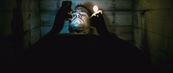 Movie still from “Buried” (2010), directed by Rodrigo Cortés – A man holding a cell phone in his hand; Close Up shot, Low angle