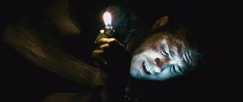 Movie still from “Buried” (2010), directed by Rodrigo Cortés – A man laying on the ground using a cell phone; Close Up shot, High angle