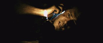 Movie still from “Buried” (2010), directed by Rodrigo Cortés – A person holding a cell phone; Close Up shot, Overhead angle