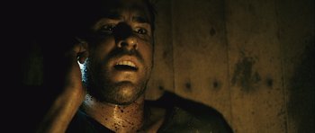 Movie still from “Buried” (2010), directed by Rodrigo Cortés – A person with dirt all over his face; Close Up shot, Low angle