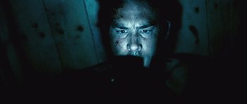 Movie still from “Buried” (2010), directed by Rodrigo Cortés – A person looking at the camera; Close Up shot, Low angle