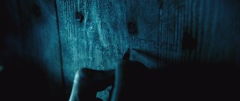 Movie still from “Buried” (2010), directed by Rodrigo Cortés – A person writing on a wall with a marker pen; Extreme Close Up shot, Overhead angle