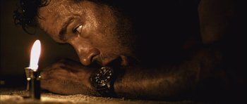 Movie still from “Buried” (2010), directed by Rodrigo Cortés – A person laying down with a watch; Extreme Close Up shot, Overhead angle