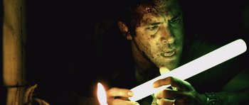 Movie still from “Buried” (2010), directed by Rodrigo Cortés – A person lighting a candle; Close Up shot, Low angle