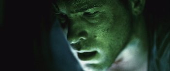 Movie still from “Buried” (2010), directed by Rodrigo Cortés – A man's face in the dark; Extreme Close Up shot, Low angle