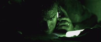 Movie still from “Buried” (2010), directed by Rodrigo Cortés – A man on a cell phone in the dark; Extreme Close Up shot, High angle