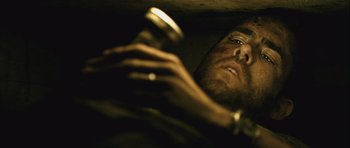 Movie still from “Buried” (2010), directed by Rodrigo Cortés – A person holding a cell phone; Close Up shot, Overhead angle