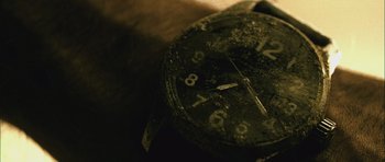 Movie still from “Buried” (2010), directed by Rodrigo Cortés – View of an old watch; Extreme Close Up shot, Overhead angle