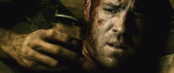 Movie still from “Buried” (2010), directed by Rodrigo Cortés – A man's face with dirt all over his face; Close Up shot, Low angle