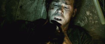 Movie still from “Buried” (2010), directed by Rodrigo Cortés – A person laying on the ground; Close Up shot, Overhead angle