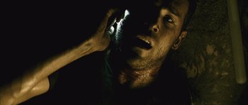 Movie still from “Buried” (2010), directed by Rodrigo Cortés – A person holding a cell phone; Close Up shot, Overhead angle