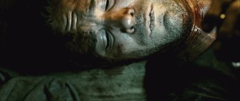 Movie still from “Buried” (2010), directed by Rodrigo Cortés – The face of a man laying on a bed; Extreme Close Up shot, Overhead angle