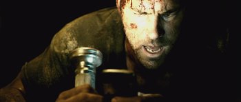 Movie still from “Buried” (2010), directed by Rodrigo Cortés – A person holding a metal object; Close Up shot, Overhead angle