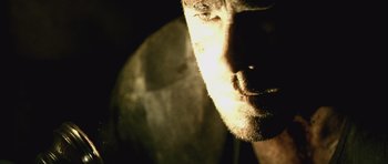 Movie still from “Buried” (2010), directed by Rodrigo Cortés – A man's face in the dark; Extreme Close Up shot, Low angle